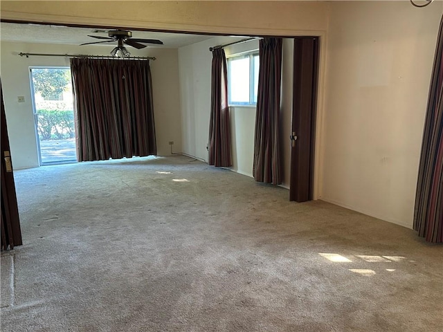 carpeted empty room with ceiling fan