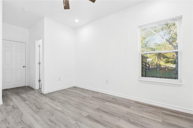 empty room featuring ceiling fan and light hardwood / wood-style floors