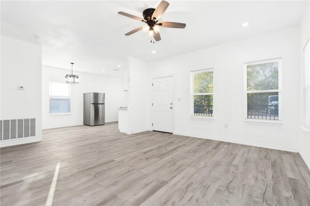 unfurnished living room featuring light hardwood / wood-style floors and ceiling fan