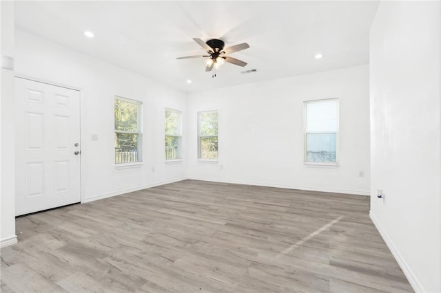 spare room with ceiling fan and light wood-type flooring