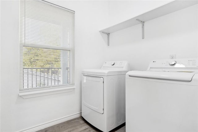 laundry area with wood-type flooring and washer and clothes dryer