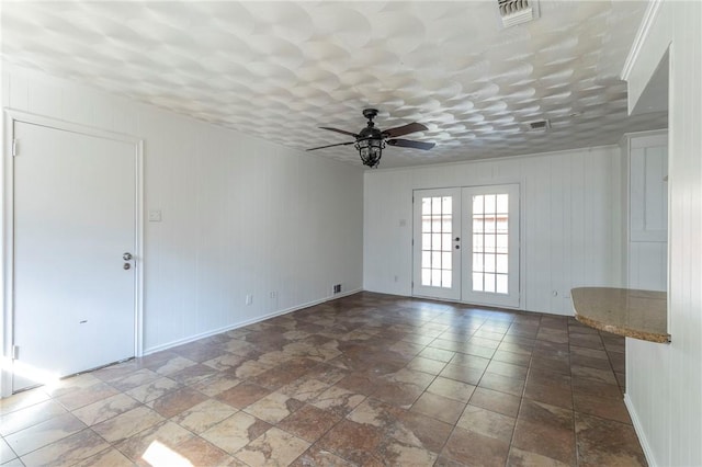 unfurnished room with french doors and ceiling fan