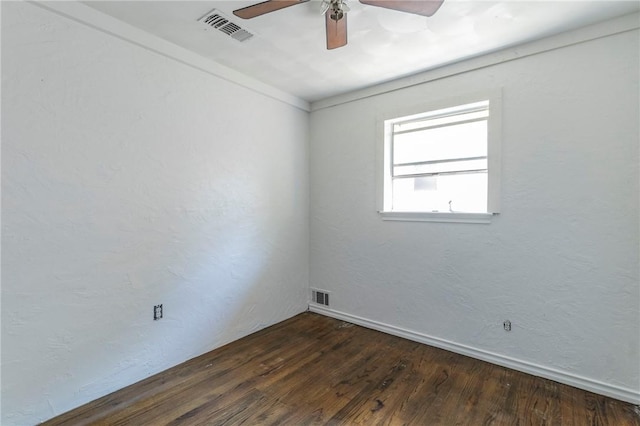 empty room with dark hardwood / wood-style flooring and ceiling fan