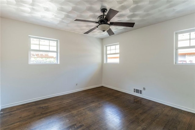 spare room featuring dark hardwood / wood-style flooring and ceiling fan