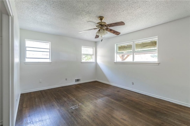 unfurnished room with a textured ceiling, ceiling fan, and dark wood-type flooring