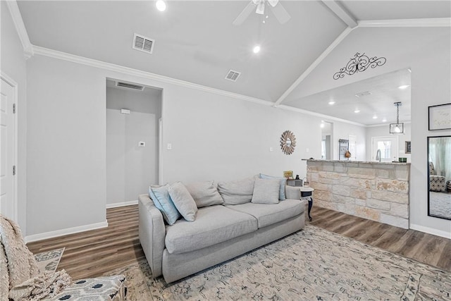 living room featuring ornamental molding, ceiling fan, hardwood / wood-style floors, and lofted ceiling with beams