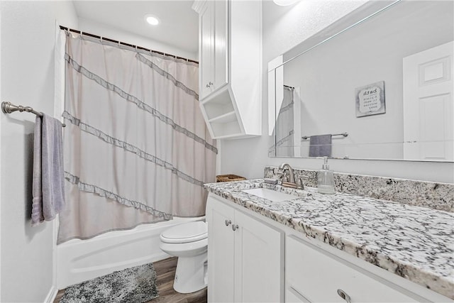 full bathroom with toilet, shower / tub combo, vanity, and wood-type flooring