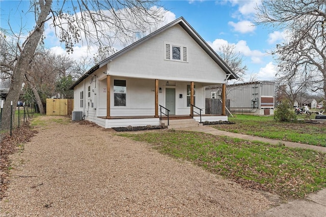 bungalow-style house with central AC unit and covered porch