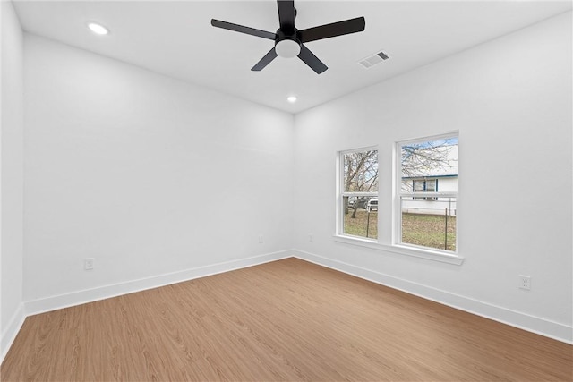 empty room featuring hardwood / wood-style flooring and ceiling fan