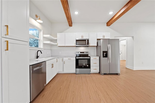 kitchen featuring white cabinetry, sink, beamed ceiling, and appliances with stainless steel finishes