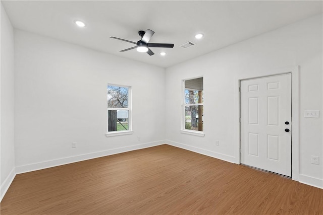 empty room with ceiling fan and hardwood / wood-style flooring