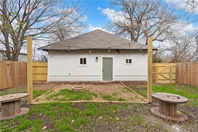 rear view of house featuring an outdoor fire pit