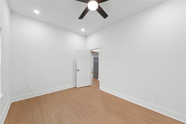 spare room with ceiling fan and light wood-type flooring