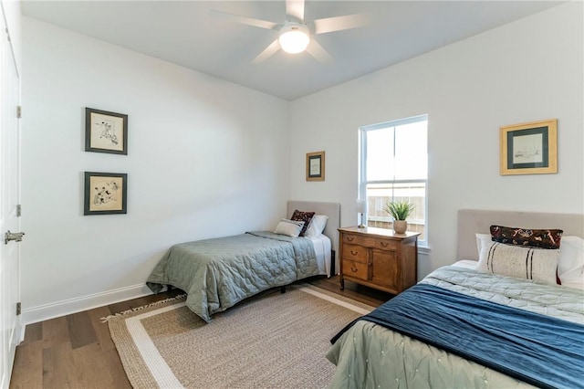 bedroom with ceiling fan and dark wood-type flooring