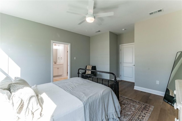 bedroom with ceiling fan, dark hardwood / wood-style floors, and connected bathroom