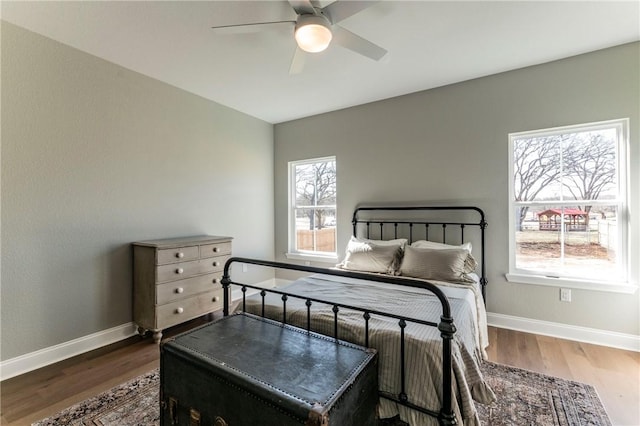 bedroom featuring dark hardwood / wood-style flooring and ceiling fan