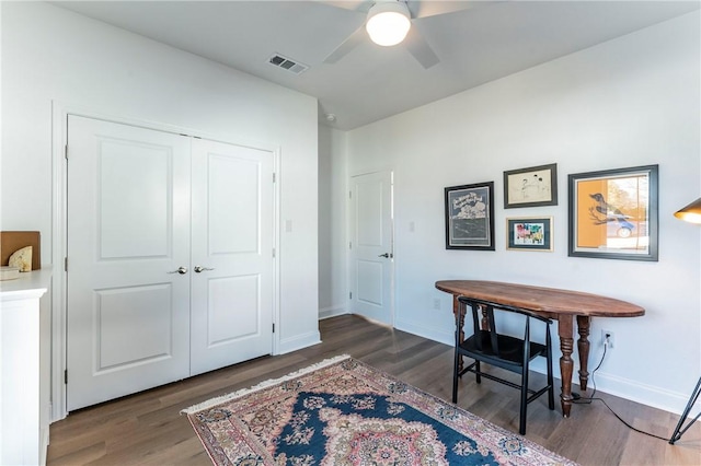 home office featuring ceiling fan and dark wood-type flooring