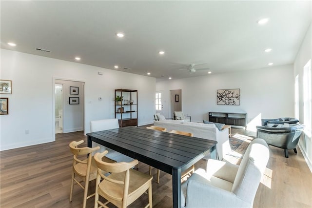 dining space with hardwood / wood-style flooring and ceiling fan