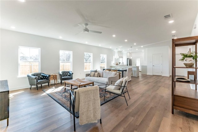 living room featuring hardwood / wood-style flooring and ceiling fan