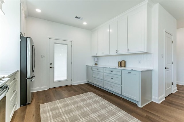 kitchen featuring white cabinets, stainless steel appliances, and dark wood-type flooring