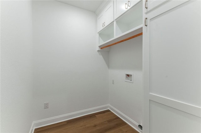 clothes washing area with cabinets, washer hookup, and dark hardwood / wood-style flooring