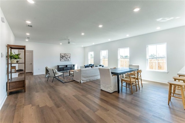 dining room with ceiling fan and dark wood-type flooring