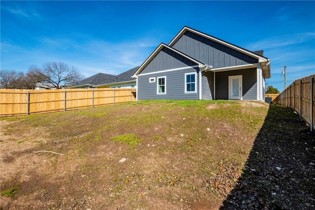 rear view of house featuring a yard