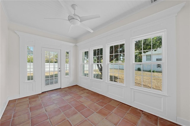 unfurnished sunroom with ceiling fan and a healthy amount of sunlight