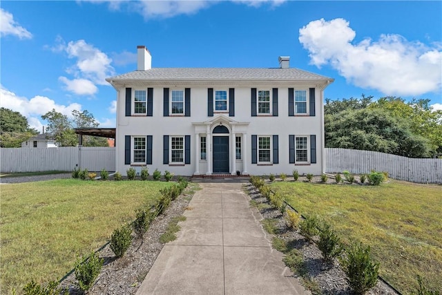 colonial home with a front lawn