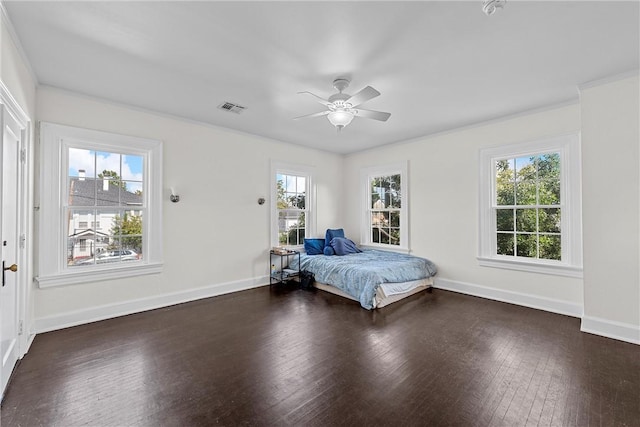 unfurnished bedroom featuring ceiling fan, dark hardwood / wood-style flooring, and multiple windows