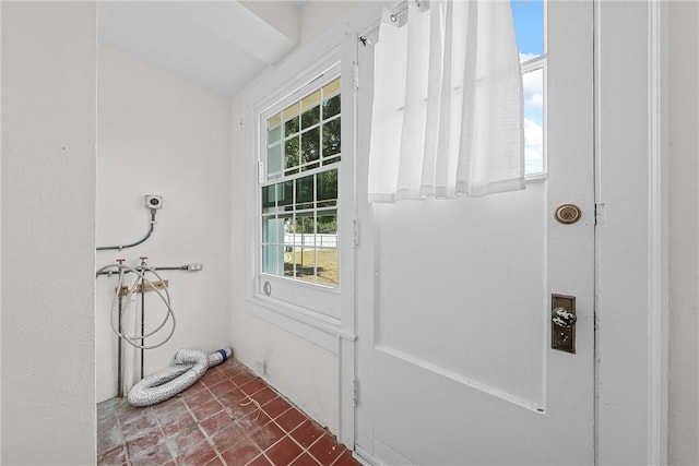 entryway featuring dark tile patterned floors