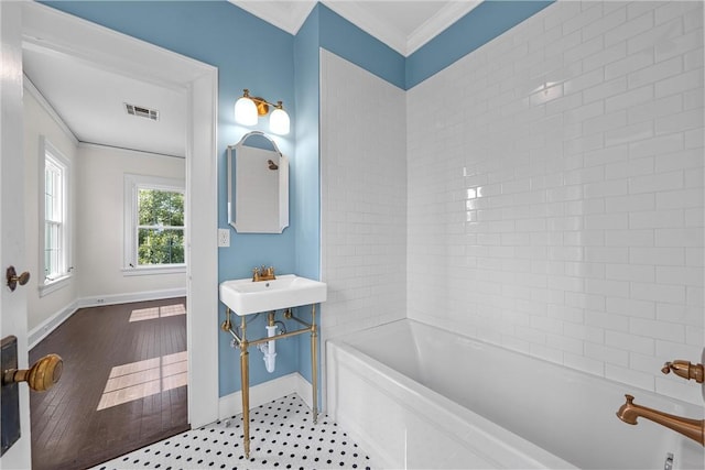 bathroom with sink, wood-type flooring, and ornamental molding