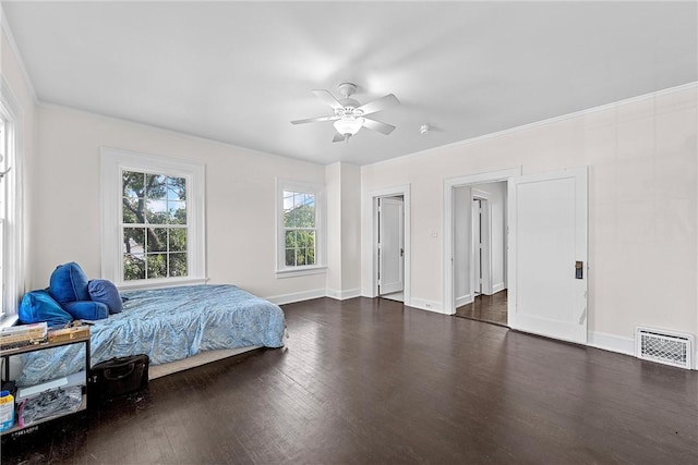 bedroom with ceiling fan, ornamental molding, and dark wood-type flooring