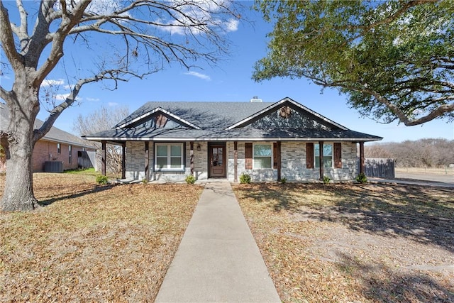 ranch-style house featuring central AC, a porch, and a front yard