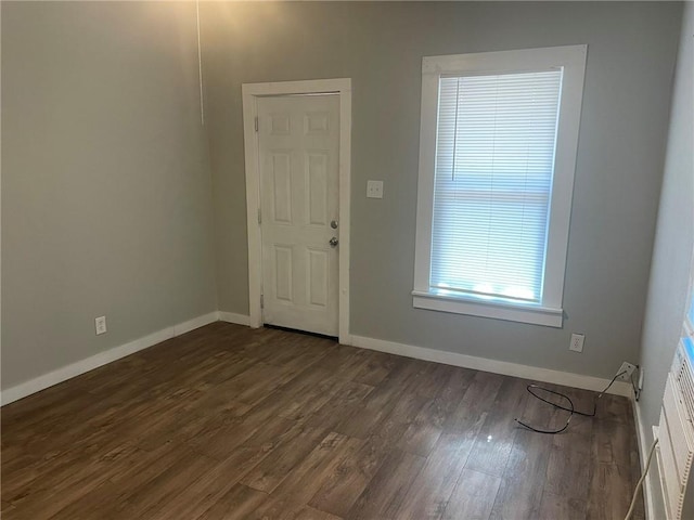 spare room featuring dark wood-type flooring