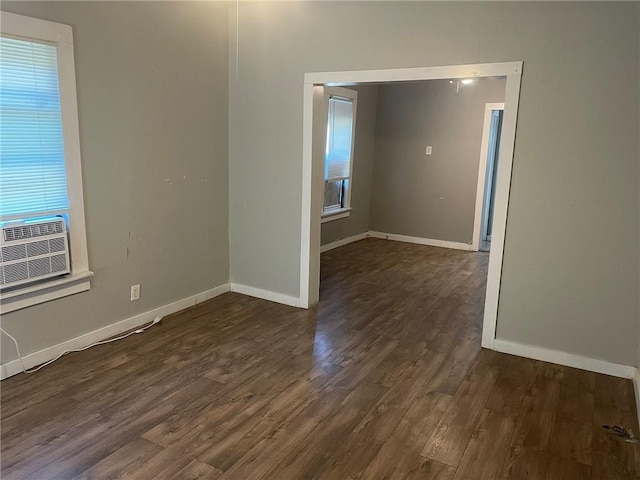 unfurnished room featuring dark hardwood / wood-style flooring and cooling unit