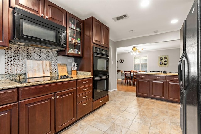 kitchen with decorative backsplash, crown molding, black appliances, and light stone counters