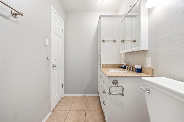 bathroom featuring tile patterned floors, vanity, and toilet