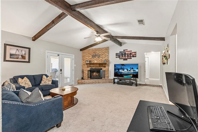 living room with french doors, lofted ceiling with beams, a brick fireplace, ceiling fan, and carpet floors