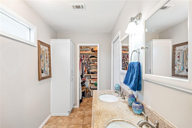 bathroom with tile patterned flooring and vanity