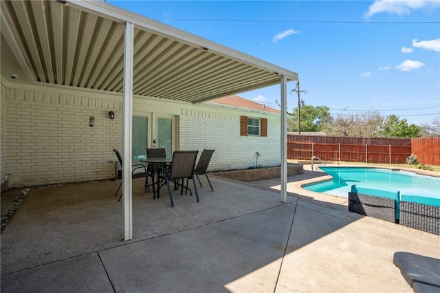 view of pool with french doors and a patio area