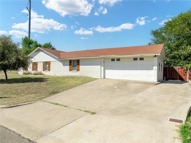 single story home with a front lawn and a garage