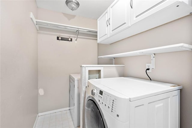 laundry area featuring cabinets and washer and clothes dryer