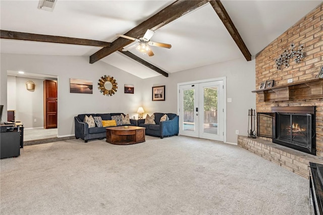 living room with french doors, a brick fireplace, vaulted ceiling with beams, ceiling fan, and light colored carpet