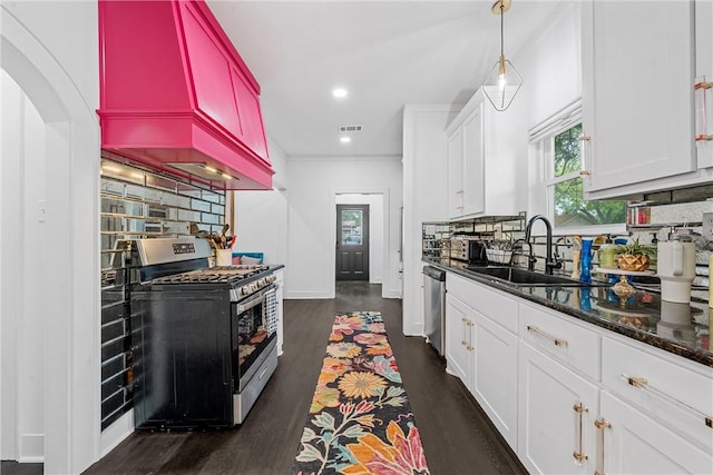 kitchen with tasteful backsplash, dark wood-type flooring, white cabinets, and stainless steel appliances