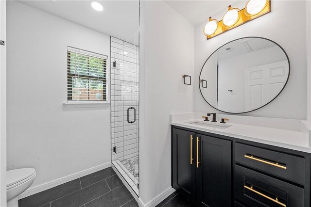 bathroom featuring tile patterned flooring, vanity, a shower with door, and toilet