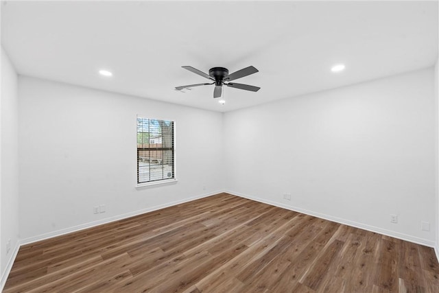 empty room with dark hardwood / wood-style floors and ceiling fan