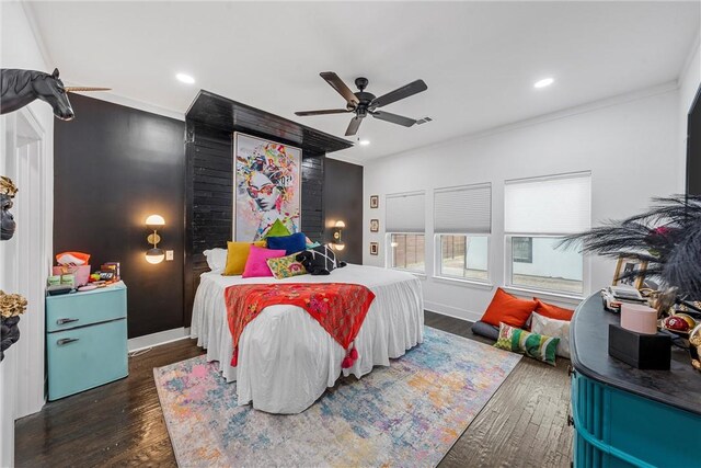 bedroom featuring crown molding, ceiling fan, and dark wood-type flooring