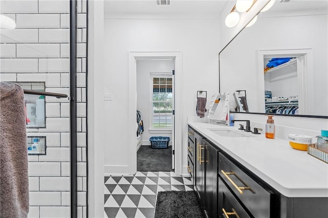 bathroom featuring tile patterned flooring and vanity