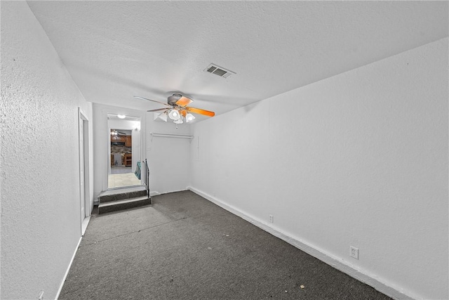 unfurnished room featuring a textured ceiling and ceiling fan